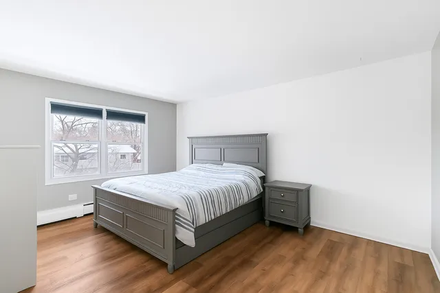 a large bed sitting in a bedroom next to a window