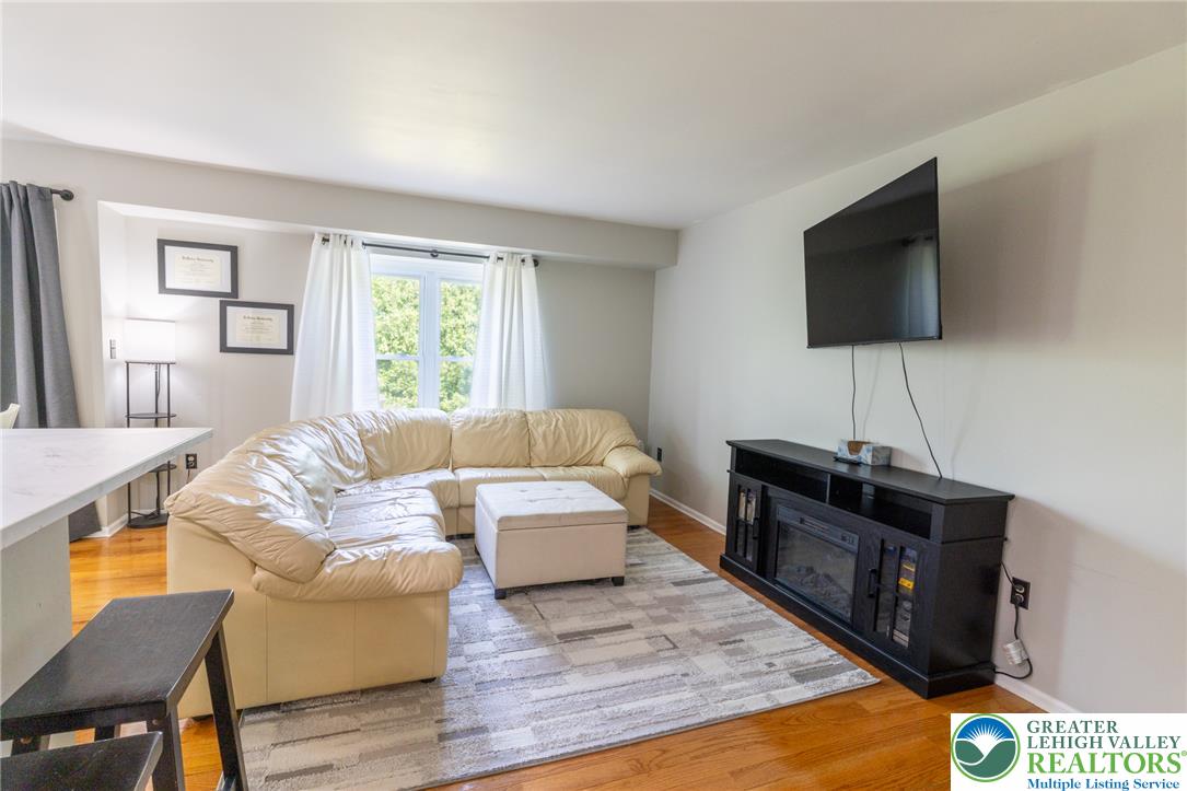 896 Briarstone Road Bethlehem, PA 18017 - Photo 3 of 26 a living room with furniture and a flat screen tv