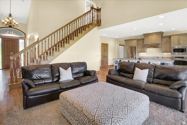 667 Hardscrabble Road Morgan, UT 84050 - Photo 12 of 51 Living room with a high ceiling, suspended lighting, and light wood-style floors