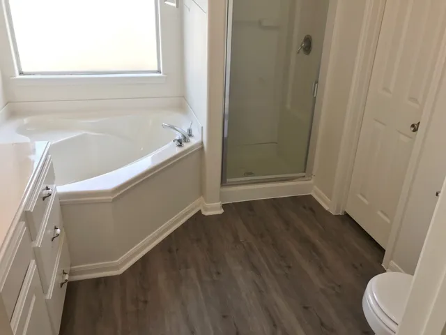 a bathroom with a bathtub and toilet