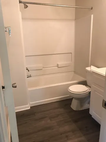 a bathroom with a toilet and a shower