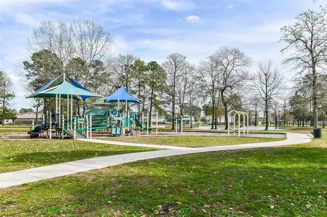 a garden view with a fountain in the background
