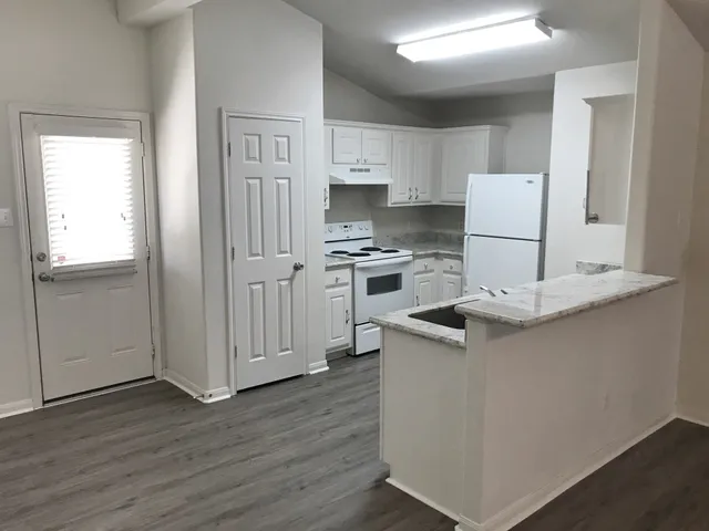 a kitchen with a sink stove and refrigerator