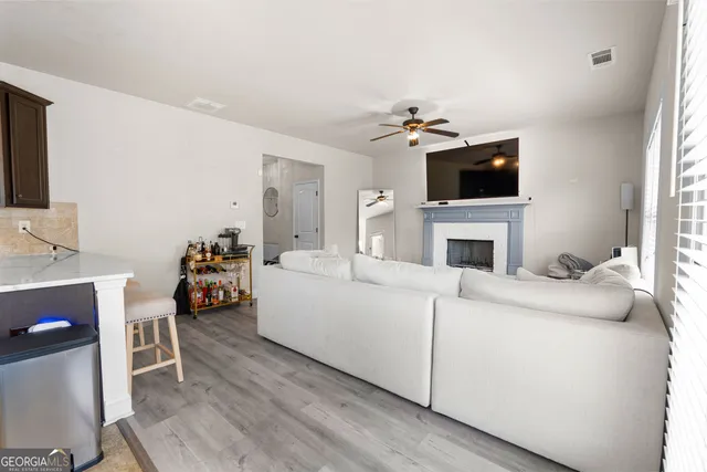 a living room with furniture a fireplace and a flat screen tv