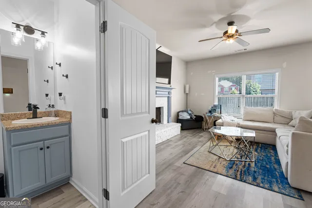 a living room with furniture a fireplace and a chandelier