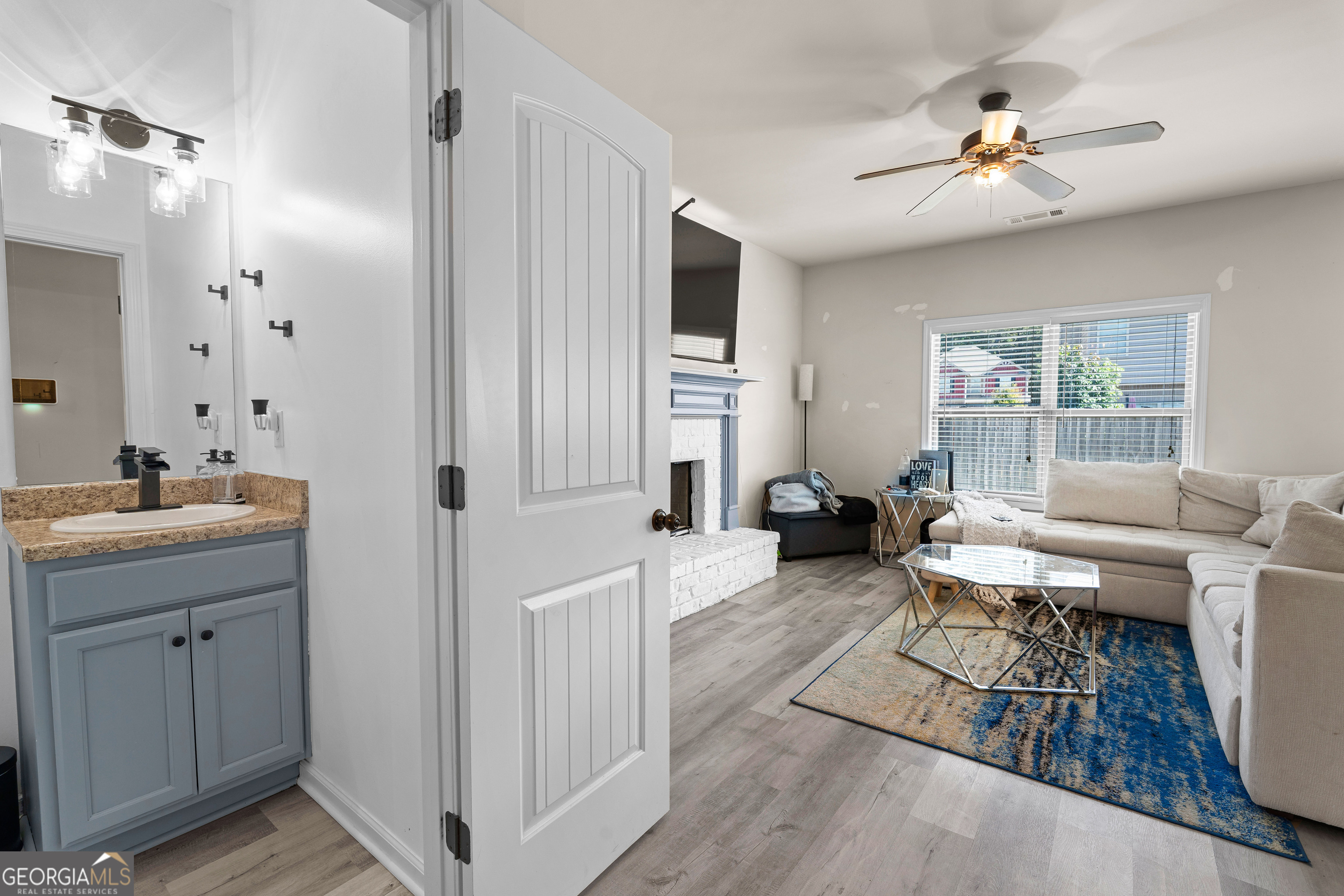 112 Truman Court Jackson, GA 30233 - Photo 16 of 41 a living room with furniture a fireplace and a chandelier