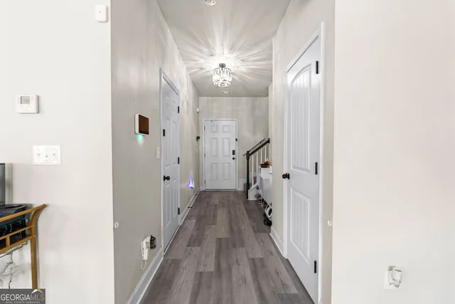 a view of a hallway with wooden floor