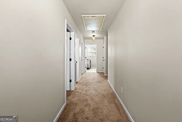 a view of a hallway with a white walls
