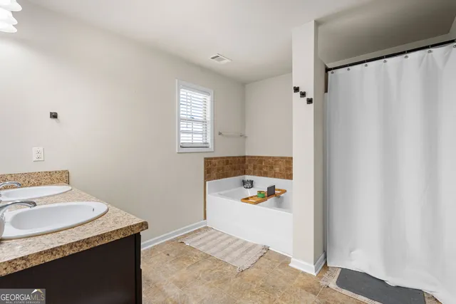 a bathroom with a sink toilet and window