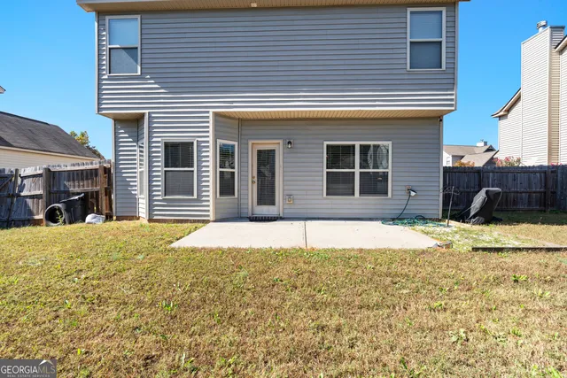 a house view with swimming pool in front of it