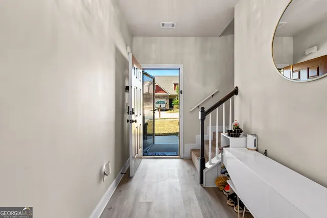 a view of a hallway view with staircase and bathroom