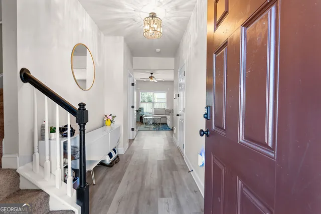 a view of a hallway view with wooden floor and staircase