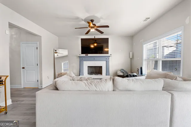 a living room with furniture a flat screen tv and a fireplace