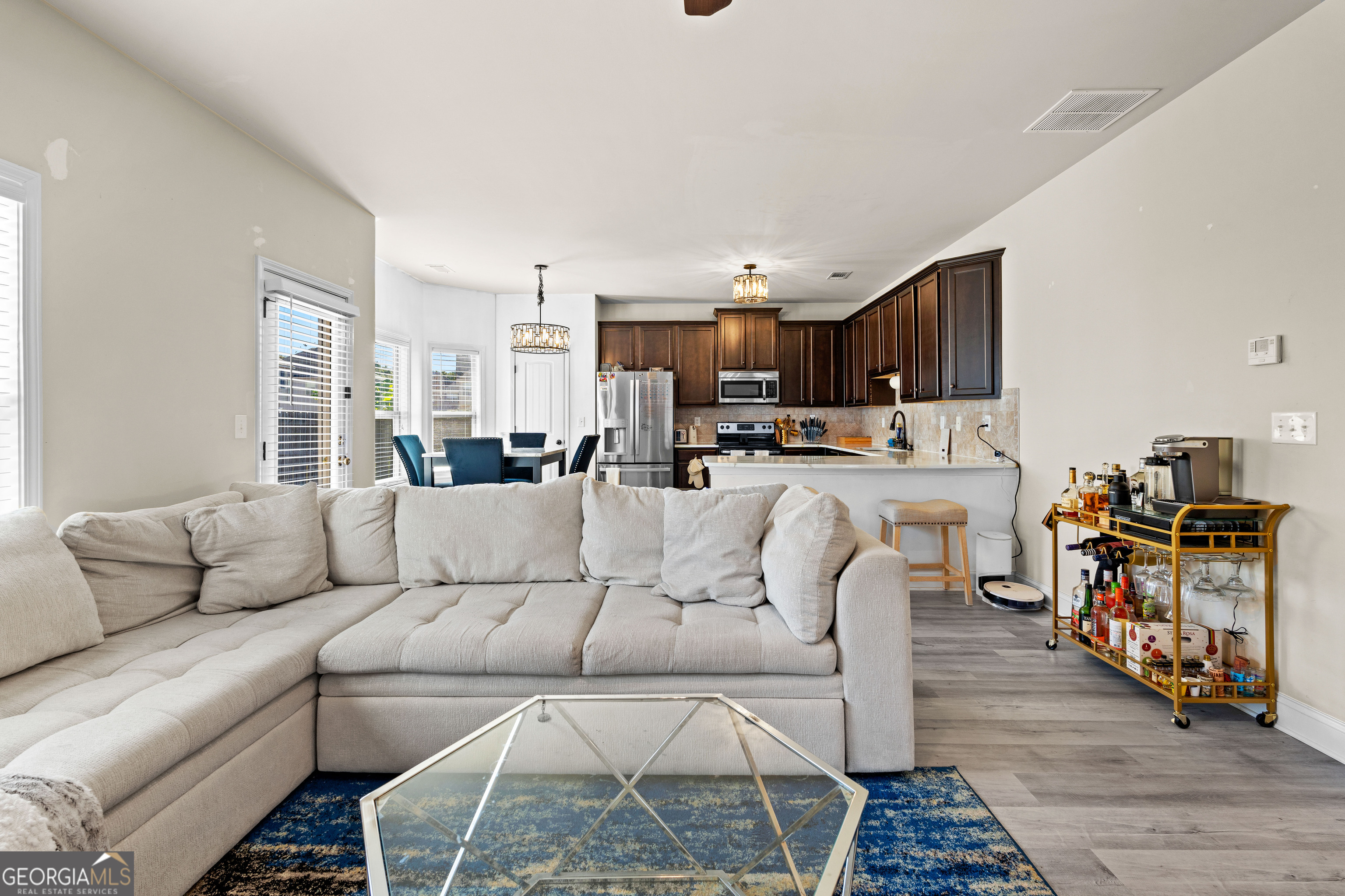 112 Truman Court Jackson, GA 30233 - Photo 9 of 41 a living room with furniture and a dining table with wooden floor