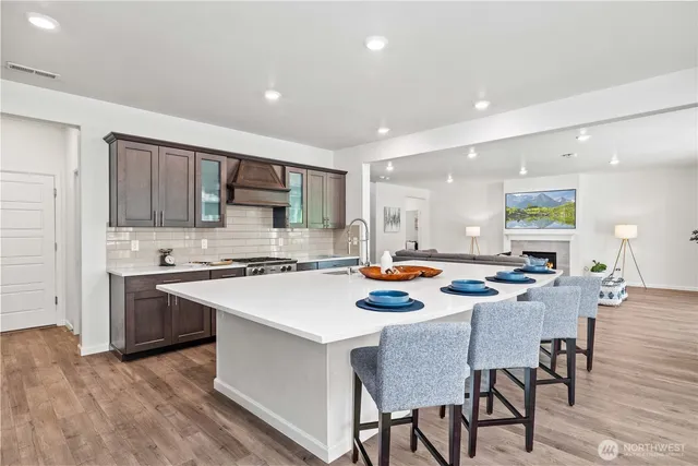 a kitchen with a stove a table and chairs in it