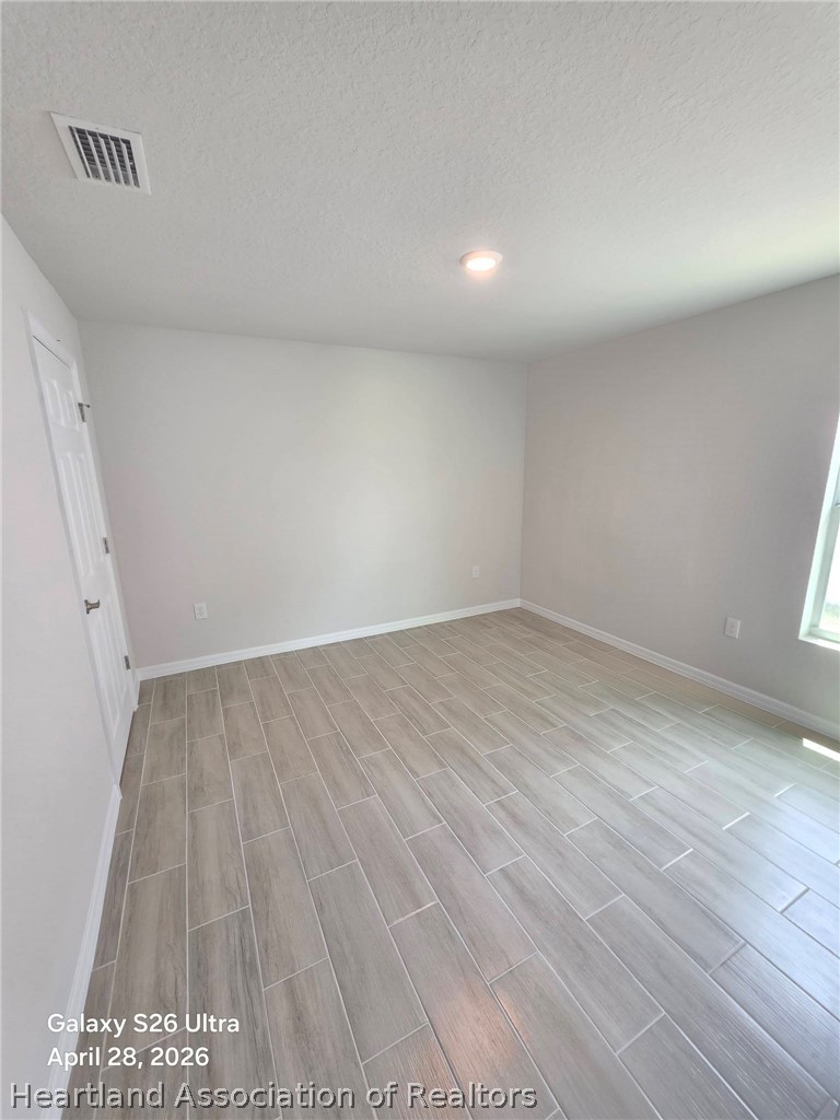 1613 Marble Street Sebring, FL 33870 - Photo 11 of 20 wooden floor in an empty room