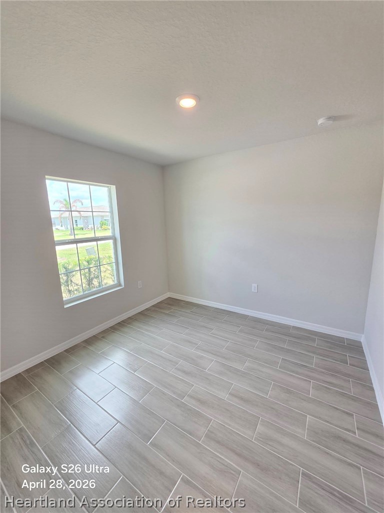 1613 Marble Street Sebring, FL 33870 - Photo 16 of 20 wooden floor in an empty room with a window