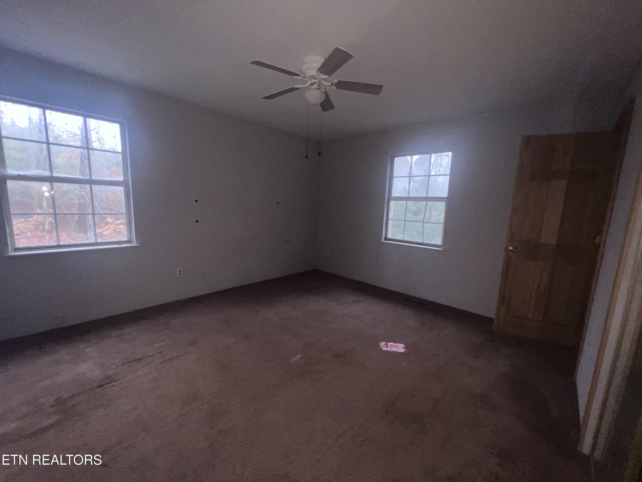 720 Poplar Lane Winfield, TN 37892 - Photo 11 of 19 an empty room with a window and a ceiling fan