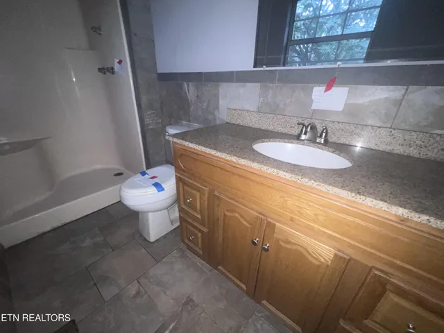 a bathroom with a sink toilet and a mirror