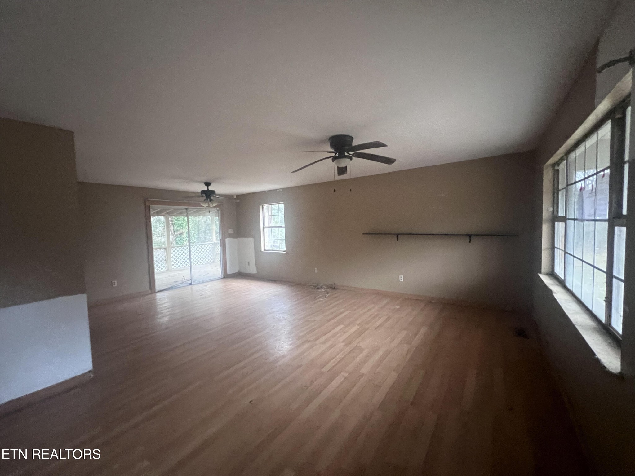 720 Poplar Lane Winfield, TN 37892 - Photo 2 of 19 a view of an empty room with a window and wooden floor