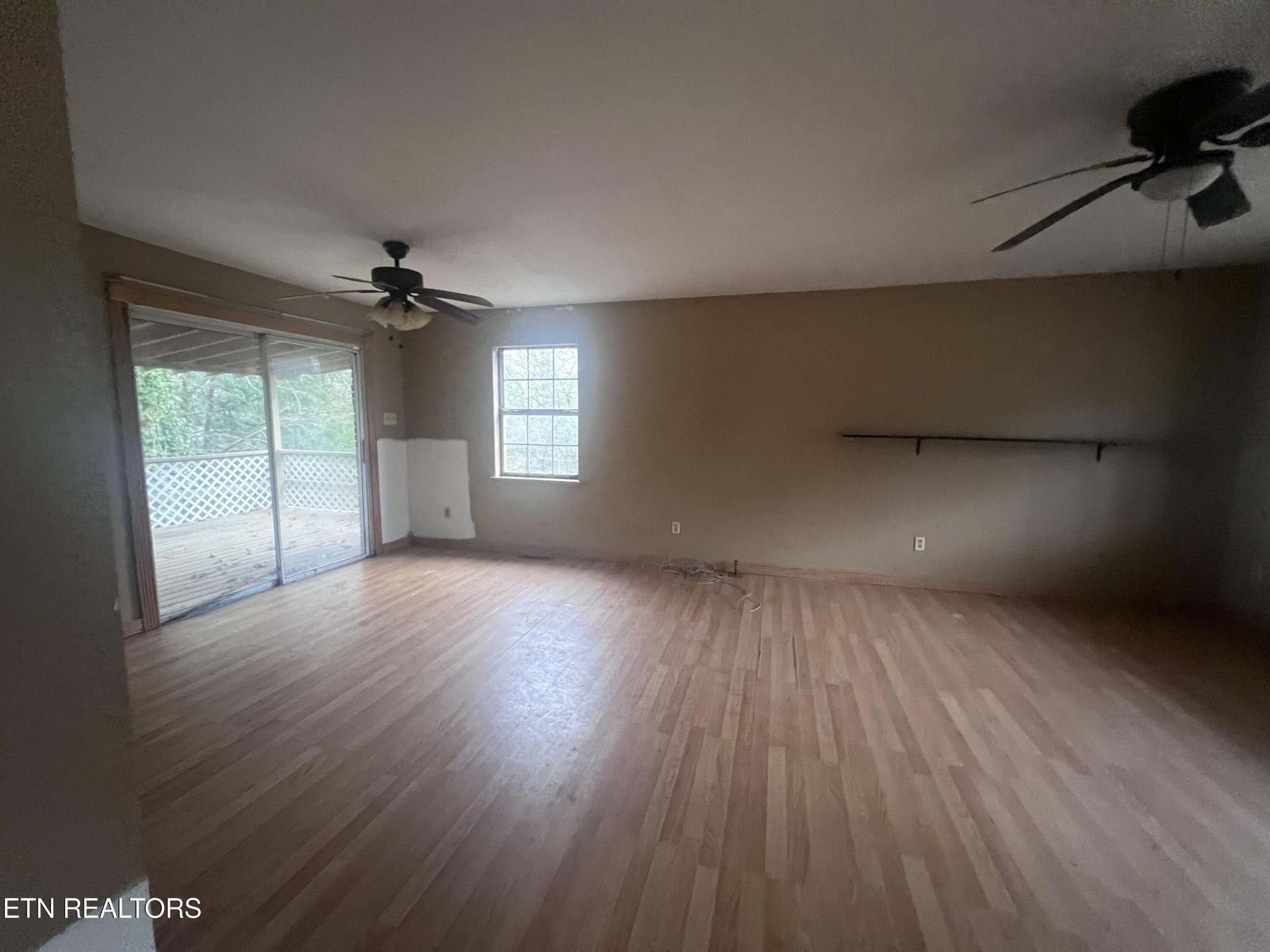 720 Poplar Lane Winfield, TN 37892 - Photo 4 of 19 wooden floor in an empty room with a window