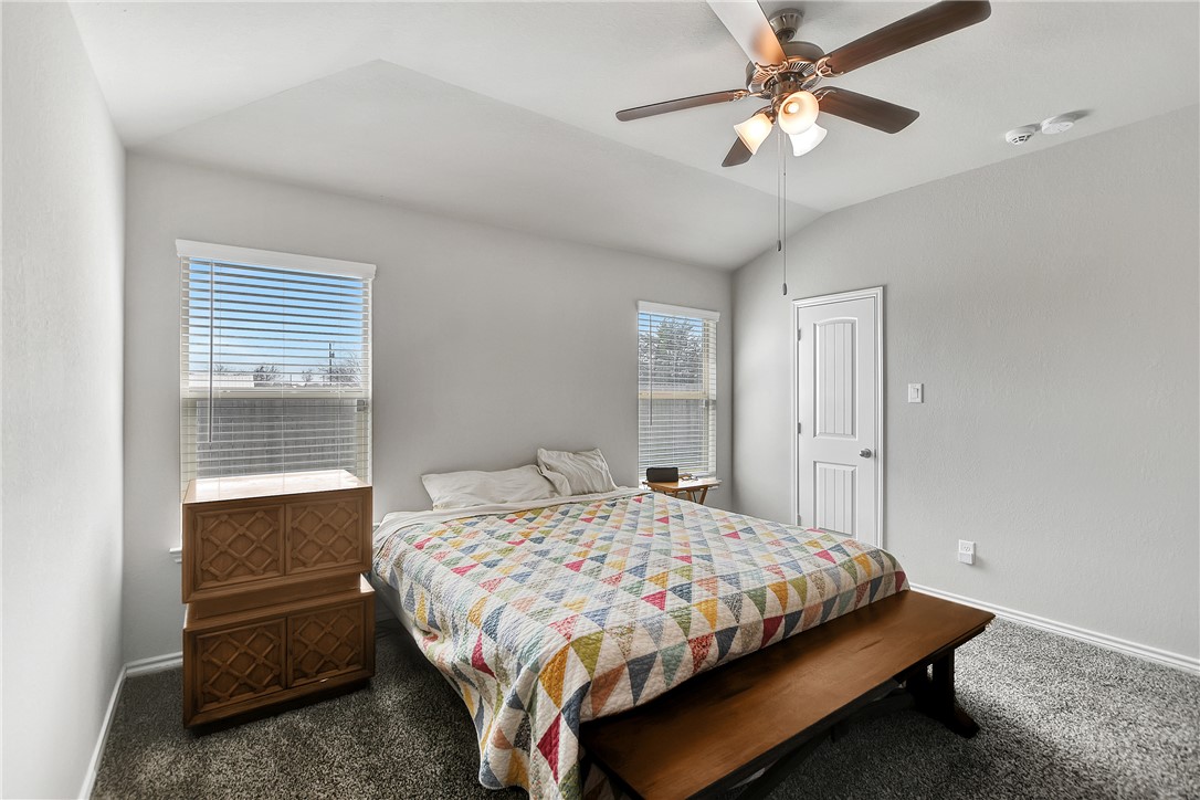 909 Davy Street Brenham, TX 77833 - Photo 17 of 35 Bedroom with lofted ceiling, carpet, and ceiling fan