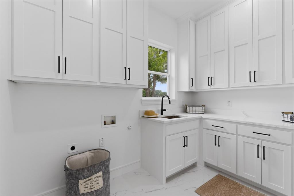 9080 County Road 669 Blue Ridge, TX 75424 - Photo 32 of 40 a kitchen with white cabinets and white appliances