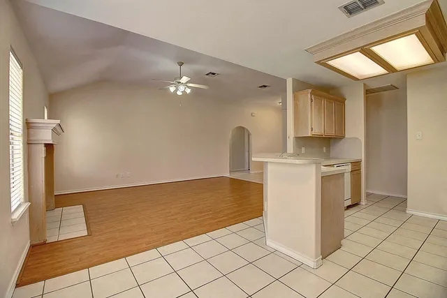 a kitchen with a stove a sink a refrigerator and cabinets