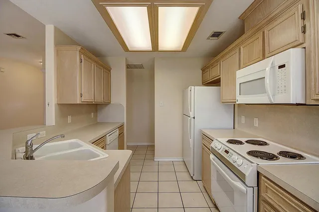 a kitchen with stainless steel appliances white cabinets and a refrigerator