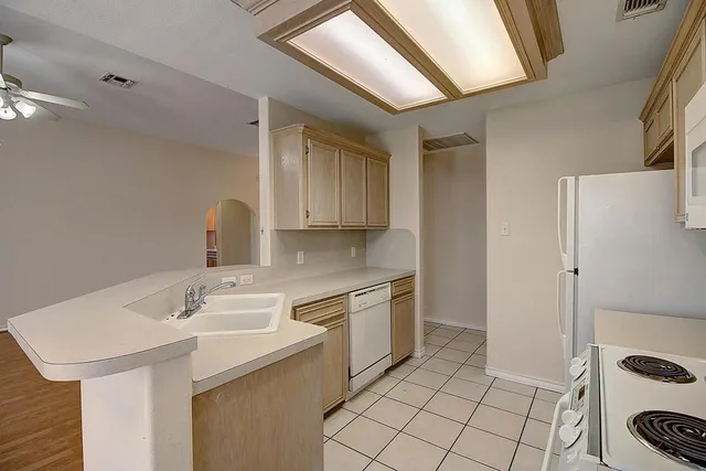 a kitchen with a sink stove and cabinets