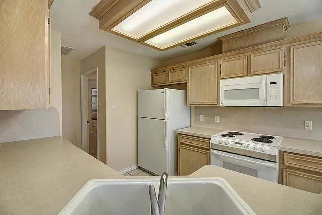 an empty room with windows and closet area