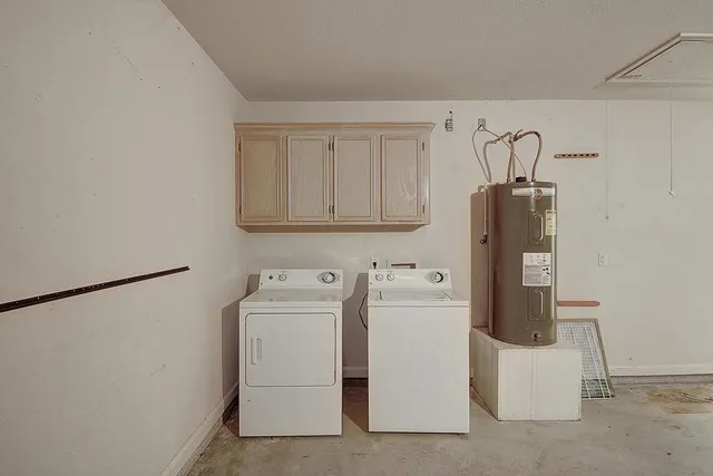 a white house with a large tree in front of it