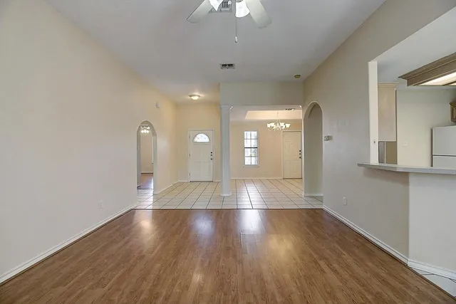 wooden floor in an empty room with a window