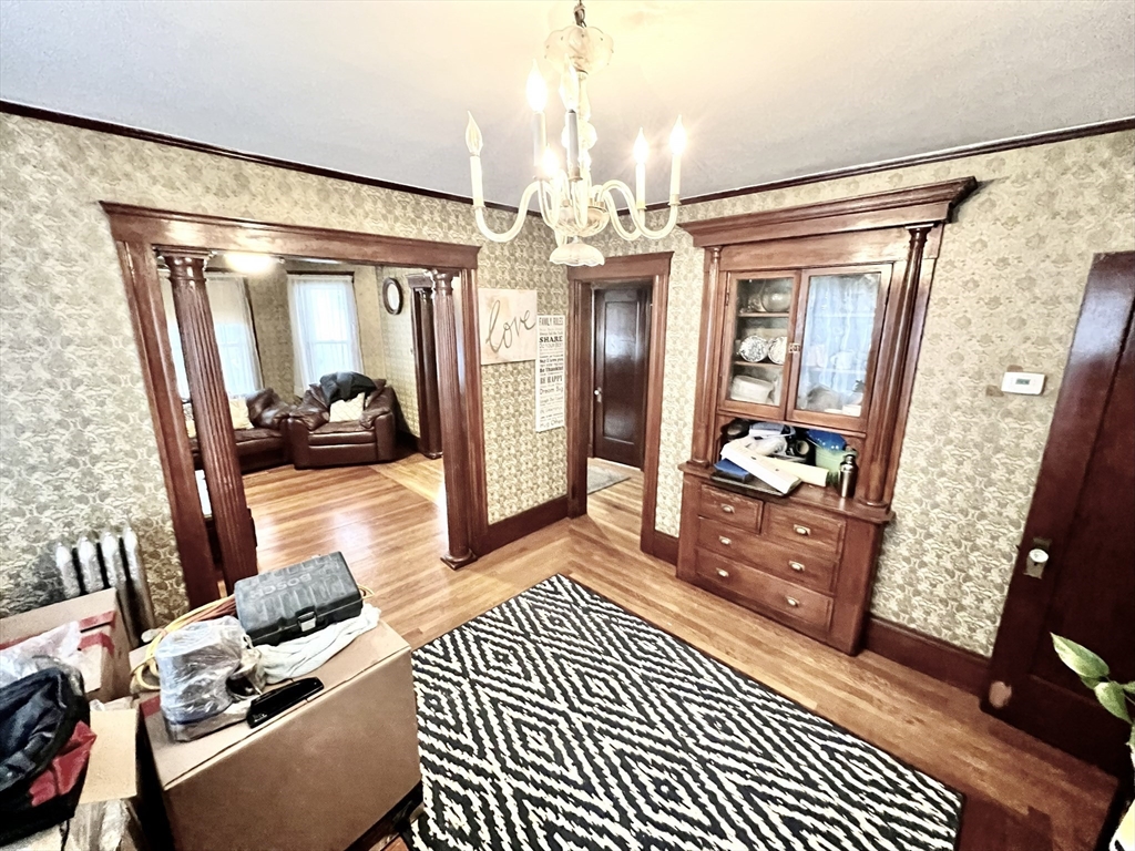 a living room with furniture and a chandelier