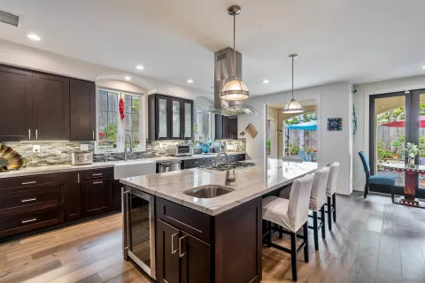 a kitchen with a sink and chairs