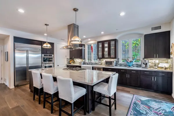 a large kitchen with a table and chairs