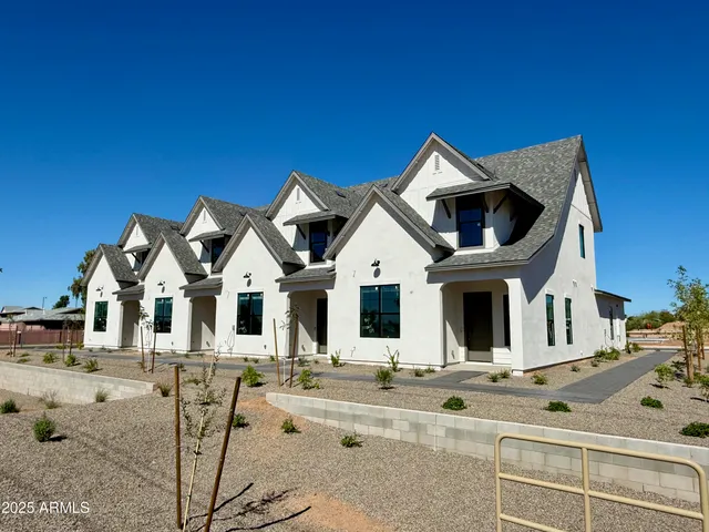 a view of a white building with many windows