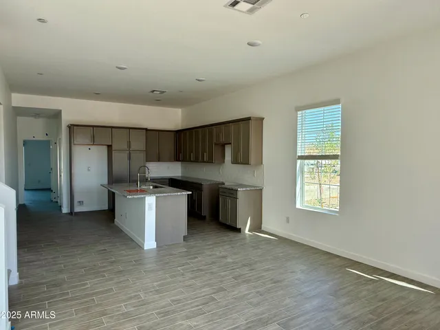a kitchen with a refrigerator and a sink