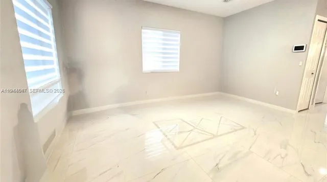 a view of an empty room and window