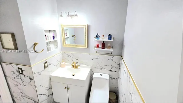 a bathroom with a sink toilet and mirror