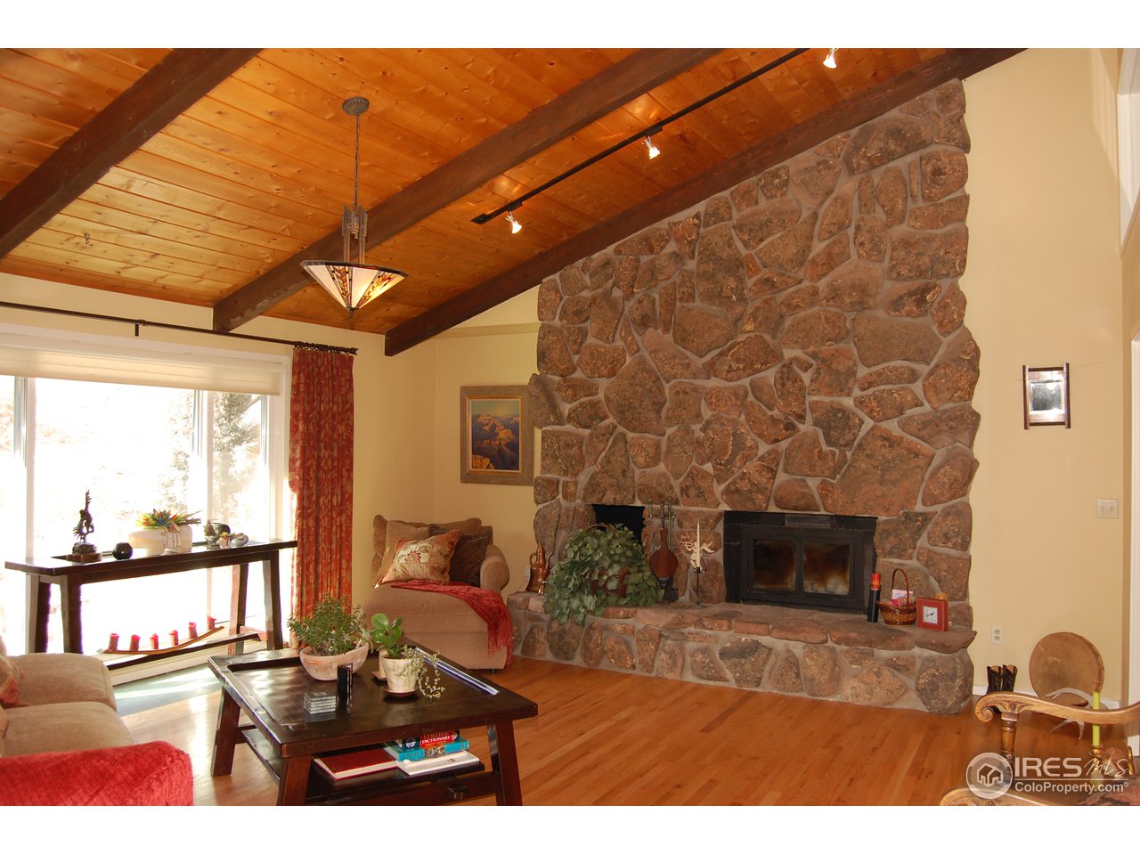 3830 Spring Valley Road Boulder, CO 80304 - Photo 7 of 18 a bedroom with furniture and a fireplace