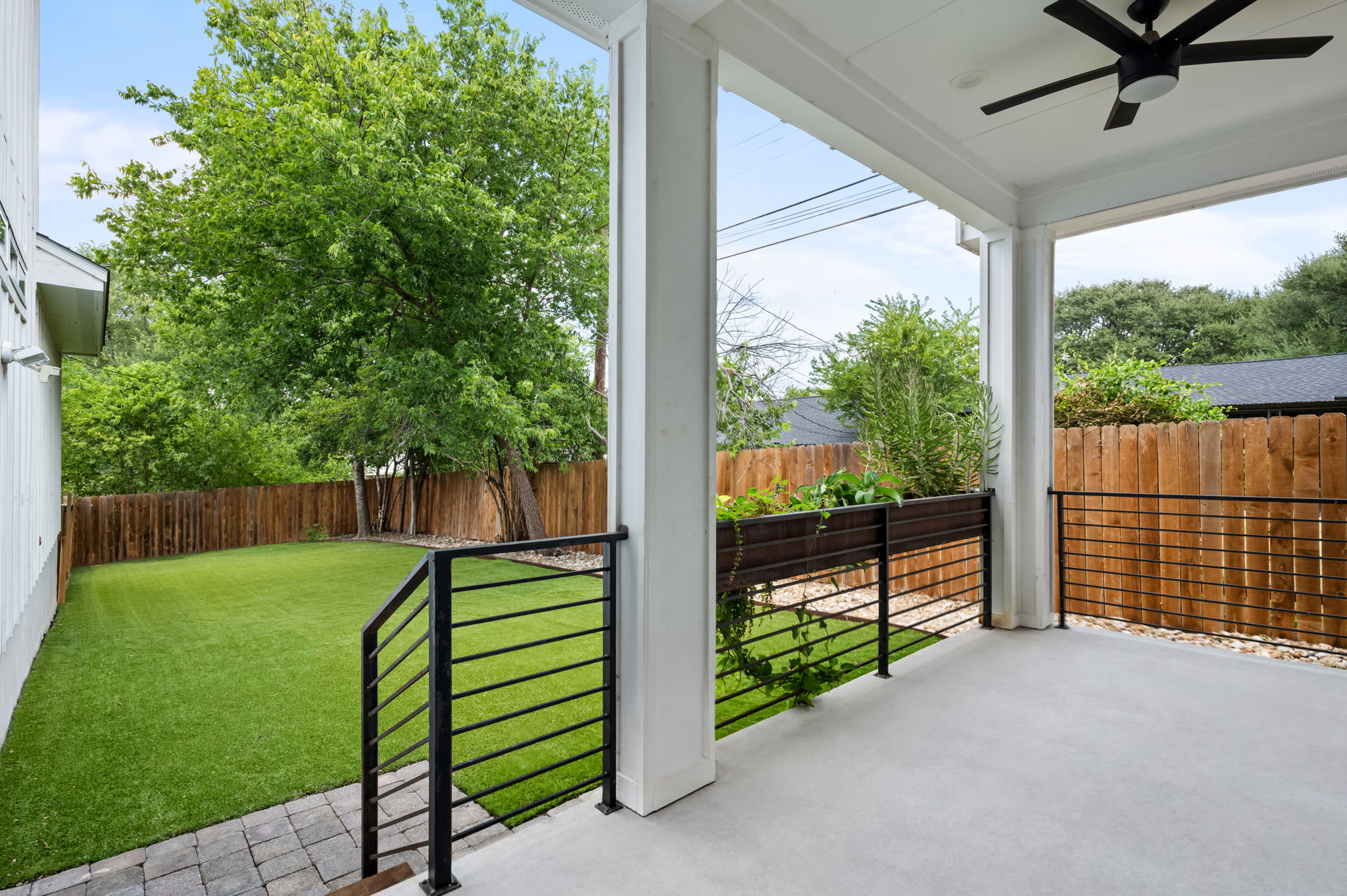 1902 Webberville Road, Unit B Austin, TX 78721 - Photo 28 of 39 An inviting covered patio transitions to a well-kept yard, perfect for outdoor enjoyment and relaxation.