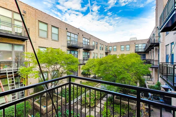 a view of a balcony with yard