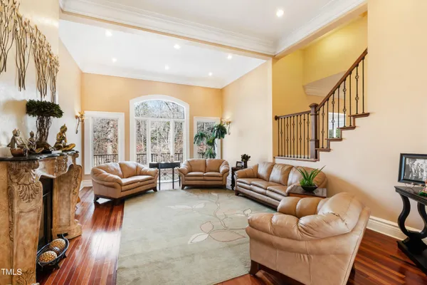 a large kitchen with stainless steel appliances granite countertop a lot of counter space and a wooden floors