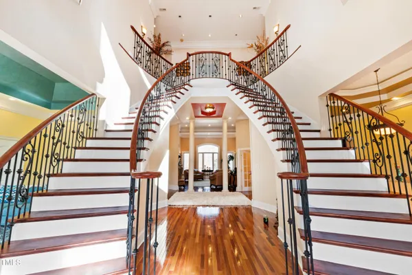 a view of entryway and hall with wooden floor