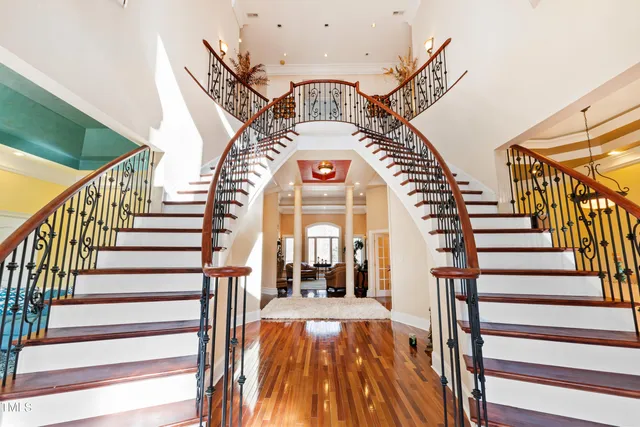 a large kitchen with stainless steel appliances granite countertop a lot of counter space and a wooden floors