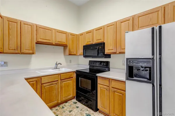 a kitchen with stainless steel appliances a refrigerator stove microwave sink and cabinets