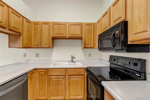 a kitchen with stainless steel appliances granite countertop a sink stove and microwave