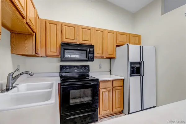 a kitchen with a sink a stove and refrigerator