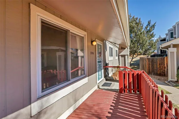 a view of balcony with two chairs and a barbeque